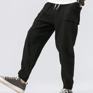 Sixtine Apparel | SOHO Modern Cargo Pants - black. Model side view.